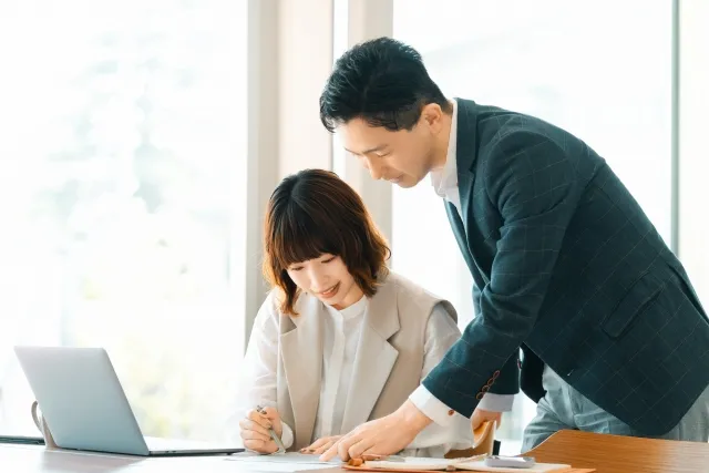 書類を見ながら相談に応じるスタッフ
